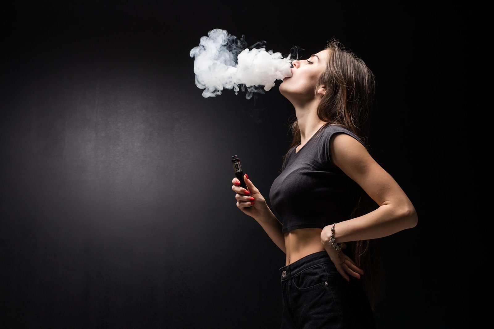 young-beautiful-brunette-woman-smoking-vaping-e-cigarette-with-smoke-black-wall-scaled.jpg